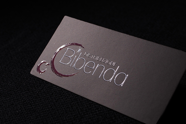 Premium dark grey mini UV business card with Bibenda logo in silver spot UV on textured fabric. Sprint24.