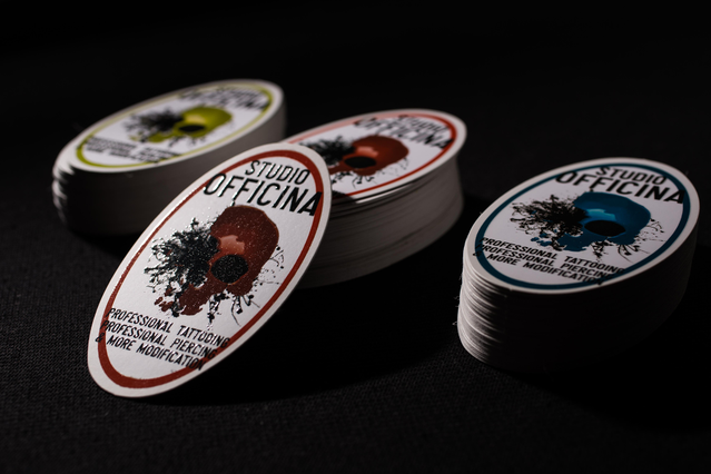 Multiple oval UV business cards Studio Officina spread Three oval UV business card stacks for Studio Officina tattoo in red brown and teal with skull. Sprint24.