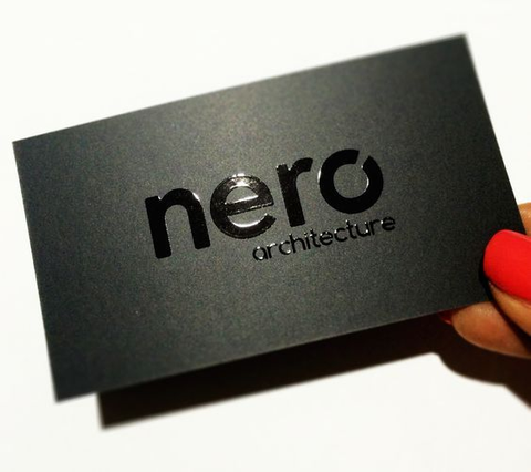 Nero Architecture black matte business card with UV gloss logo held. Matte black premium business card Nero Architecture with UV gloss raised logo for architects. Sprint24.