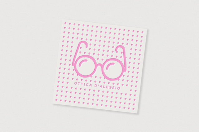 Square UV business card for Ottica D'Alessio with playful pink glasses on white polka dot background. Sprint24.