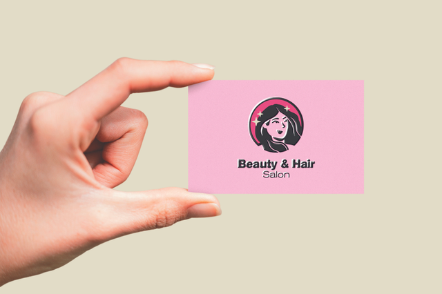 Hand holding soft pink UV business card Beauty Hair Salon with female face illustration. Sprint24.
