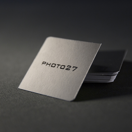 Premium business card design showcasing the elegant silver metallic finish with UV varnish protection. Perfect for creative professionals like videographers and content creators who need to make a lasting impression. The UV coating enhances durability while adding a sophisticated, reflective quality to every card.