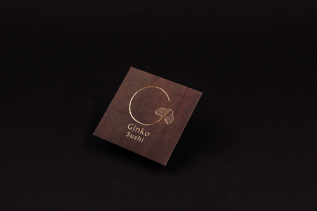 Square gold 3D business card Ginko Sushi dark Square dark brown business card for Ginko Sushi with gold leaf circular design in 3D UV. Sprint24.