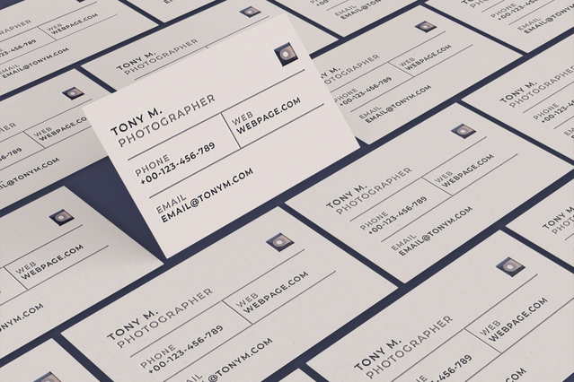 Multiple white business cards for 'Tony M. Photographer' fanned in a grid showing the clean minimal design with web, phone and email contact details. These UV-printed photography business cards combine professional typography with a pristine white background — ideal for photographers seeking elegant, high-quality branded cards that convey creativity and professionalism.