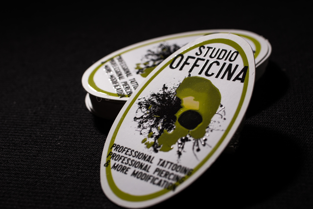 Innovative UV varnish business card with artistic motel-key concept for tattoo studios. Sprint24.